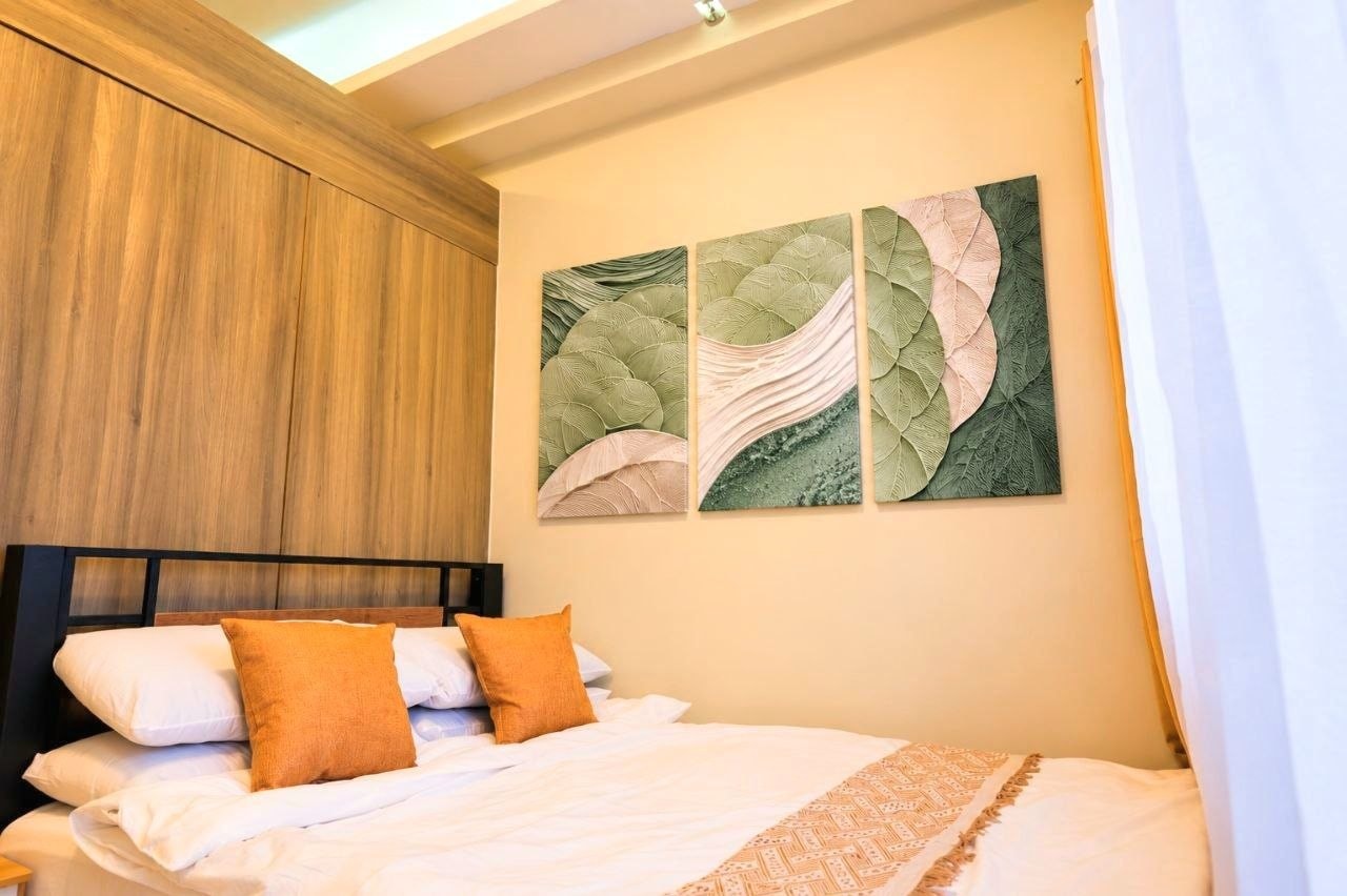 Second bedroom with botanical wall art