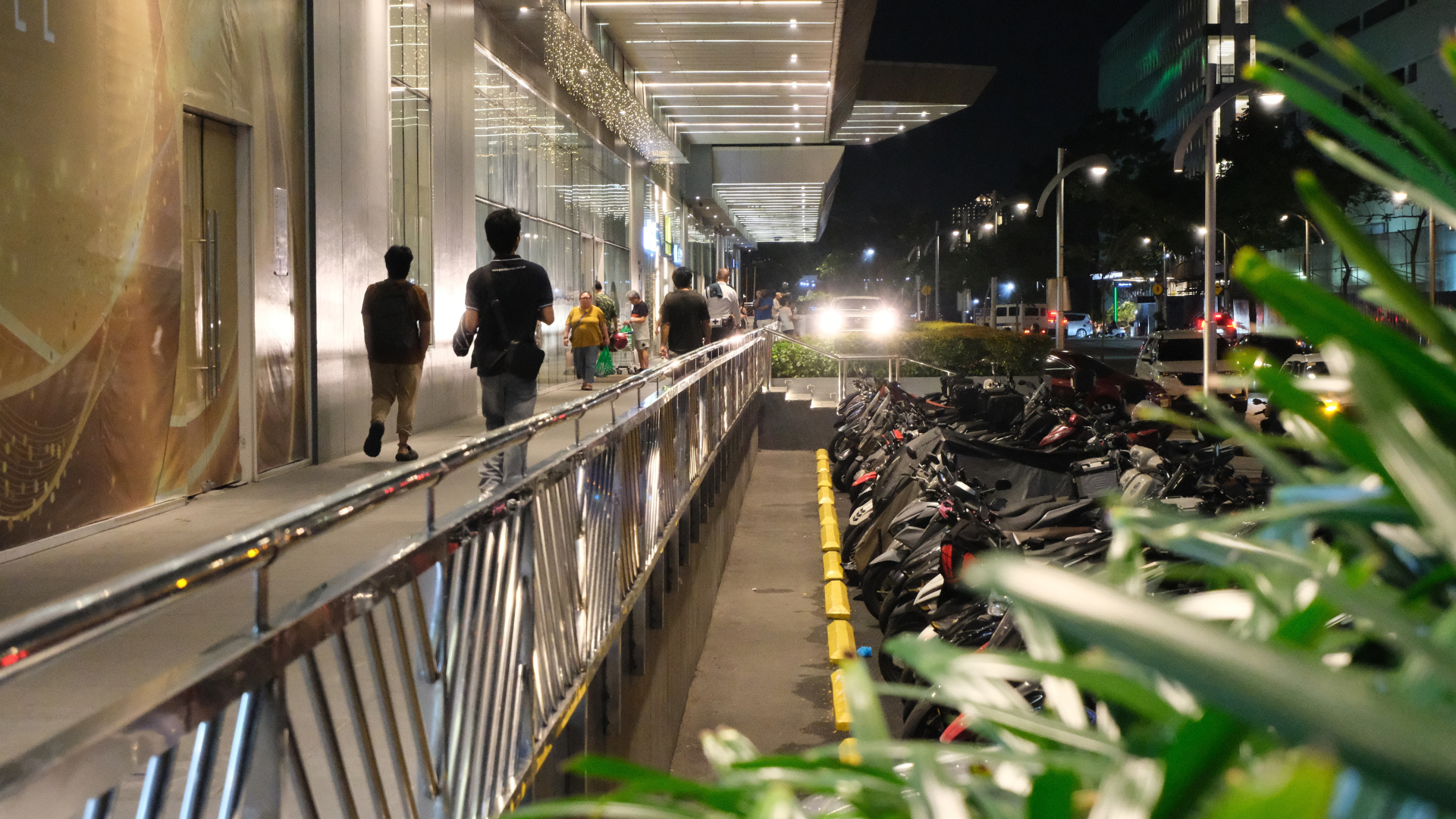 Pedestrians on Shaw Boulevard at night