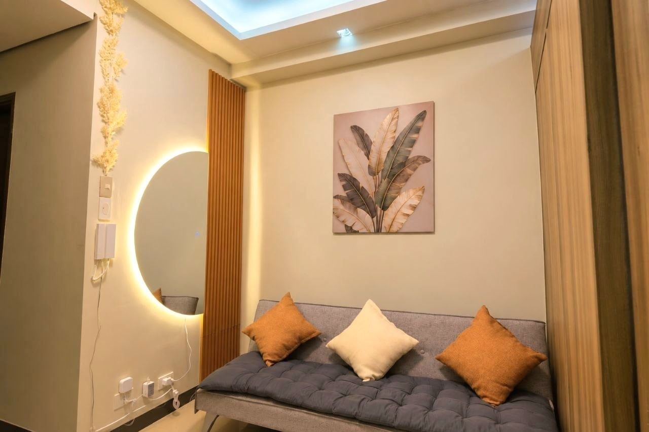 Bedroom with illuminated round mirror